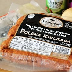 a bag of polish kielbasa sitting on top of a table next to other foods