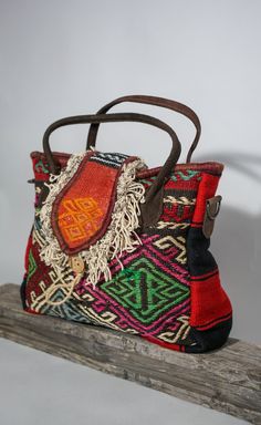 "Hand Woven Antique Rug and Leather Combination Boho Style Crossbody Tote Bag || Ethnic Shoulder Bag Kilim rugs are beautiful art pieces with a story to tell. The lives, cultural beliefs, and spirit of the Anatolian people are woven into attractive patterns and intriguing motifs rich with hidden meaning and mythical symbolism.  Each vintage rug used to make these unique bags carries a history of 60-80 years and is completely hand-made using natural wool, vegetable dyes, and methods that are centuries old.  As no two are the same, your rug bag will be one of a kind. Item Details Size of the bag: Width: 38 cm - '' 15 Height: 32 cm - 12,5'' Depth: 11 cm - 4,30'' Internal Pocket Measurements:  Width: 15 cm - 6,9'' Height: 20 cm - 7,9'' Length of the shoulder strap : Min: 71cm - 28\" Max: 126cm Traditional Handwoven Satchel For Travel, Artisan Multicolor Shoulder Bag, Traditional Satchel For Everyday Use, Traditional Brown Bag With Weaving Work, Artisan Rectangular Shoulder Bag With Woven Motifs, Traditional Style Tote Shoulder Bag For Travel, Artisan Shoulder Bag With Woven Motifs, Traditional Travel Bag With Woven Motifs, Traditional Weaving Work Shoulder Bag For Everyday