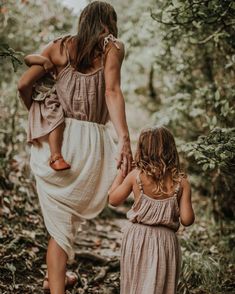 mother and daughter walking in the woods together