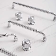 the handles and knobs of a kitchen faucet are shown in polished chrome