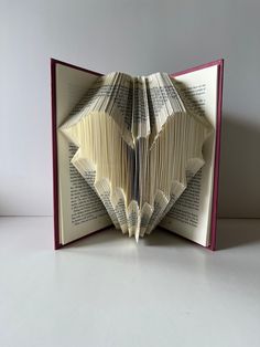 an open book with pages folded in the shape of origami