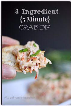 a hand holding a cracker with crab dip on it and the words 3 ingredients 5 minute crab dip