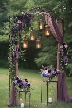 an outdoor ceremony with purple flowers and lanterns