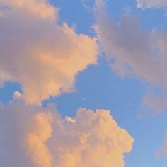 an airplane is flying in the sky with clouds