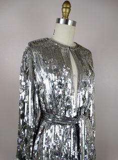 "This is another AMAZING vintage piece! It's fully embellished with eye-catching reflective sequins and is in perfect condition! Measurements: Bust - 40\" Shoulders - 16\" Sleeves - 21\" Top to Bottom - 31\" All of my items come from a smoke-free and pet-free home. If you have any questions, please don't hesitate to ask!" Disco Style Embellished Sequin Fabric For Evening, Checkered Jacket, Mirror Silver, Sequin Jacket, Beaded Gown, Silk Jacket, Silver Sequin, Silver Mirrors, Embellished Dress