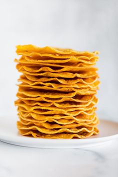 stack of corn tortillas on a white plate