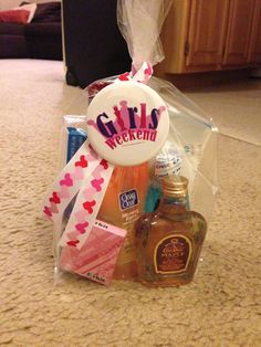 a gift basket with bottles and condiments on the floor