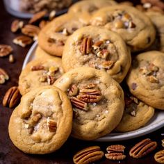 a plate full of cookies with pecans on the side