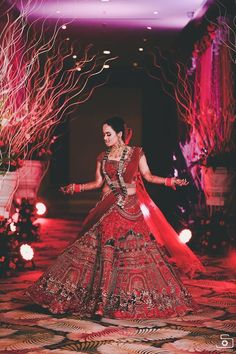 a woman in a red and gold bridal gown