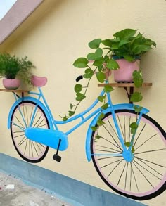 a blue bicycle with potted plants attached to it