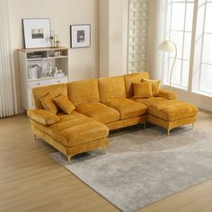 a living room with a yellow couch and rug