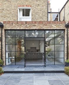 an open patio with glass doors leading to the kitchen