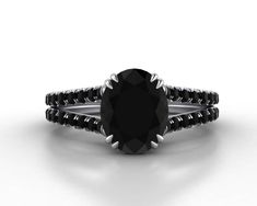 a black diamond engagement ring on a white background