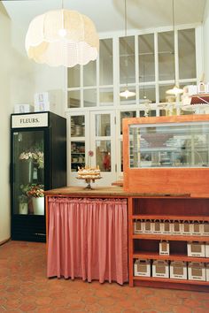 a bakery with lots of food on display in the front and behind it is a light fixture