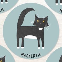 a black cat with yellow eyes and the words mackenzie on it's back