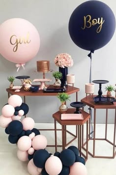 balloons, cake and other decorations are arranged on the table for a genderal celebration