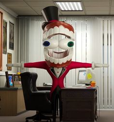 an office cubicle with a giant inflatable man standing next to a desk