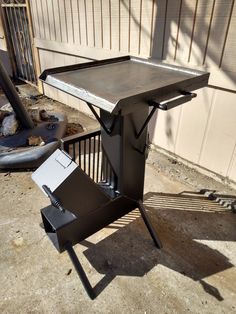 a table with a laptop on it sitting in front of a fenced off building