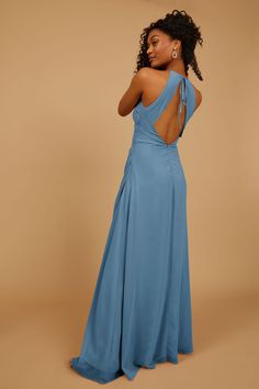 a woman in a blue dress is looking back