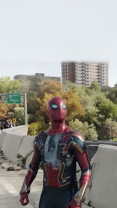 a man dressed as spider - man walking down the street