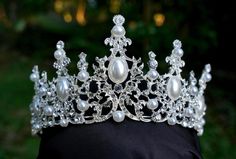 This stunning Tiara Crown is crafted from tarnish resistant zinc alloy and intricately decorated with crystals to create an elegant look ideal for any special occasion, including weddings, quinceañeras, birthdays, pageants and more. **WEARING YOUR CROWN OR TIARA** Most pieces are adjustable by carefully bending and separating the ends to desired fit. Loops are featured in the design for securing to hair with bobby pins or clips **SHIPPING** All orders are sent within 24 hours from Florida, USA. Tiara Silver, Crown Birthday, Tiara Crown, Bridal Crown, Florida Usa, Tiaras And Crowns, Wedding Hair Accessories, White Pearl, Pearl White