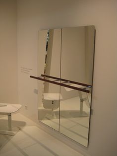 a bathroom with a large mirror on the wall