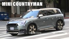 the mini countryman is driving down the street