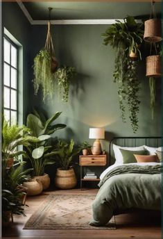 a bedroom with green walls and plants hanging from the ceiling