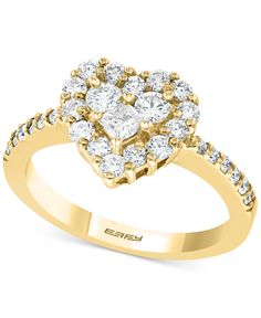 a yellow gold engagement ring with diamonds on the shoulders and center stone in the middle