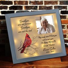 a framed photo with a cardinal on it and the words goodbyes are not forever