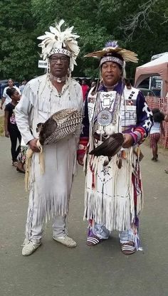 two native american men standing next to each other