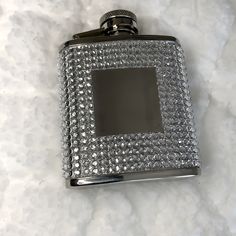 a silver flask with lots of diamonds on it