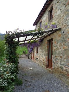 an old stone building with vines growing on it