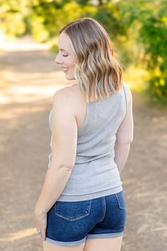 Elevate your style with the Tara Ribbed Tank in sophisticated grey! This tank combines fun and fashion with its micro ribbed texture and high neckline. Perfect for any occasion, it offers a comfortable fit that you'll love. Fabric Composition: 93% rayon, 7% spandex for a soft and stretchy feel.Fit: True to size.Model Sizing: Catherine and Tiffanee are wearing a small, and Lexi is in a 1XL. Upgrade your wardrobe with the Tara Ribbed Tank, a must-have versatile piece. Stretch Ribbed Gray Tops, Gray Ribbed Tank Top For Spring, Gray Stretch Tank Top For Fall, Gray Stretch Tops With Ribbed Neckline, Bath And Body Shop, Kids Graphic Tees, Jumpsuit Shorts Rompers, Leggings Kids, Ribbed Texture