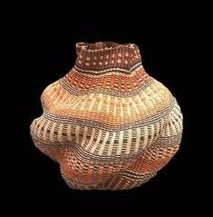 a brown and white vase sitting on top of a table