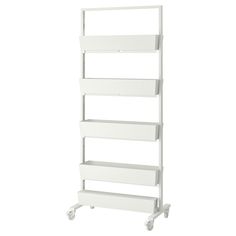 a white shelf with four shelves on wheels and three drawers in the bottom, one is empty