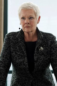 an older woman sitting in front of a window