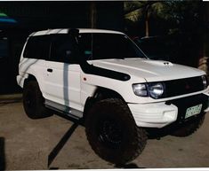 a white suv parked in a parking lot at night