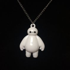 a white necklace with a small cartoon character on it