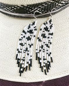 Hand made beaded fringe earrings, featuring a black and white fleck and  white cow pattern (moo!) with black bead embellishments. Black And White Beaded Earrings, White Beaded Earrings, Beaded Fringe Earrings, Native American Earrings, White Cow, Beaded Jewlery, Cow Pattern, Beaded Fringe, Fringe Earrings