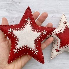 two red and white stars are in someone's hand