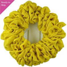 a yellow scrunffle wreath on a white background