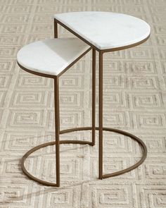 a white table sitting on top of a carpet covered floor next to a metal stand