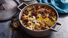 a pot filled with lots of food on top of a table