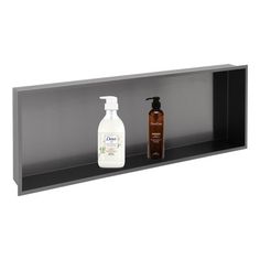 the shelf is black and has two bottles on it, one with soap and another with lotion