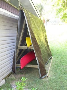 a tent that has been set up in the grass with two yellow chairs under it