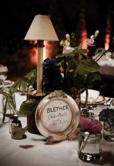 the table is set with flowers, candles and other things to be used as decorations