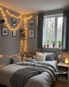 a bedroom with lights on the wall and a bed in front of a large window