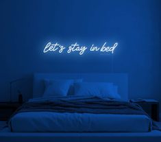 there is a neon sign that says let's stay in bed