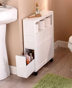 a bathroom with a toilet, sink and cabinet next to the bathtub in it